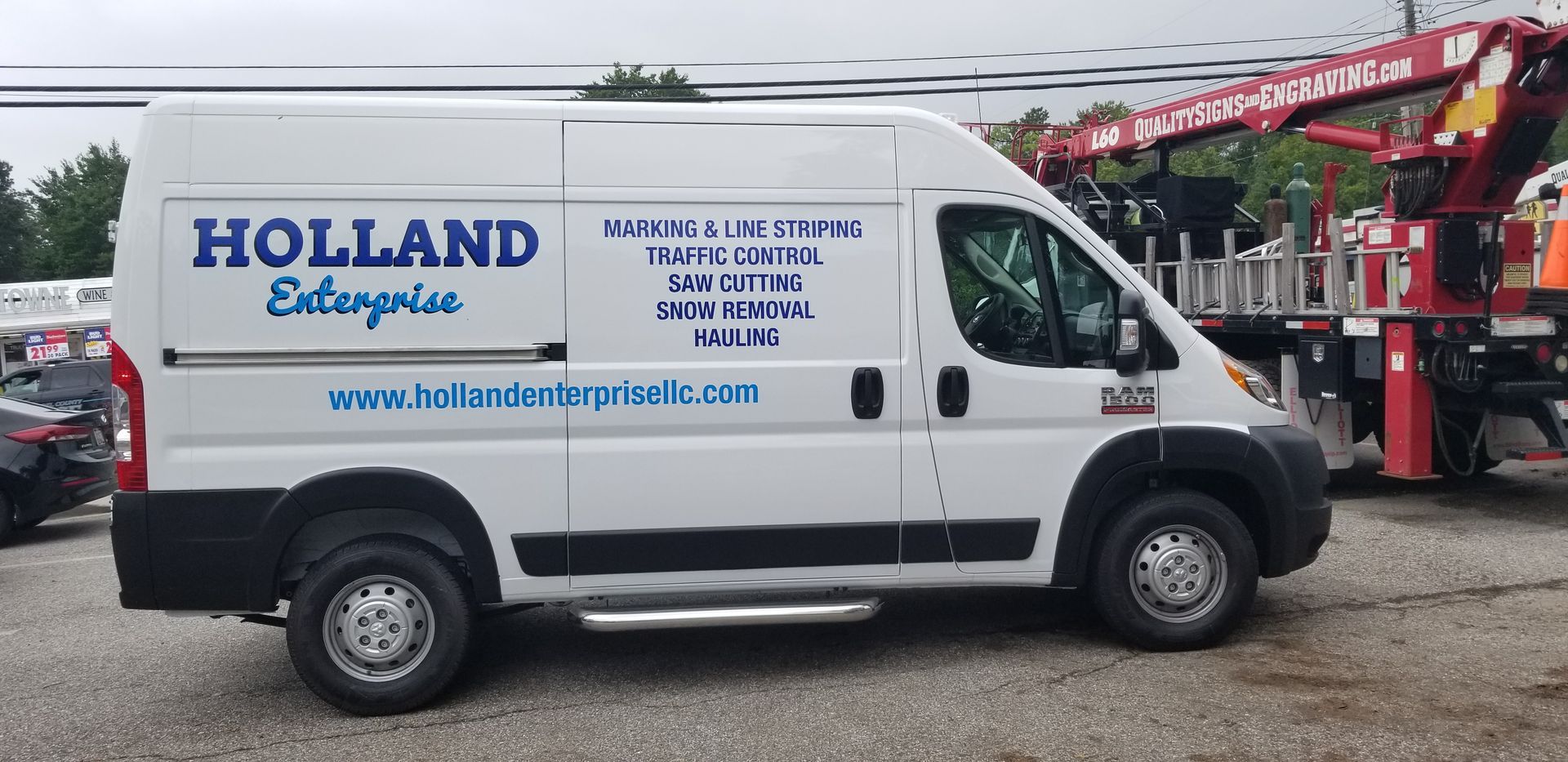 A white van that says holland enterprise is parked in a parking lot.