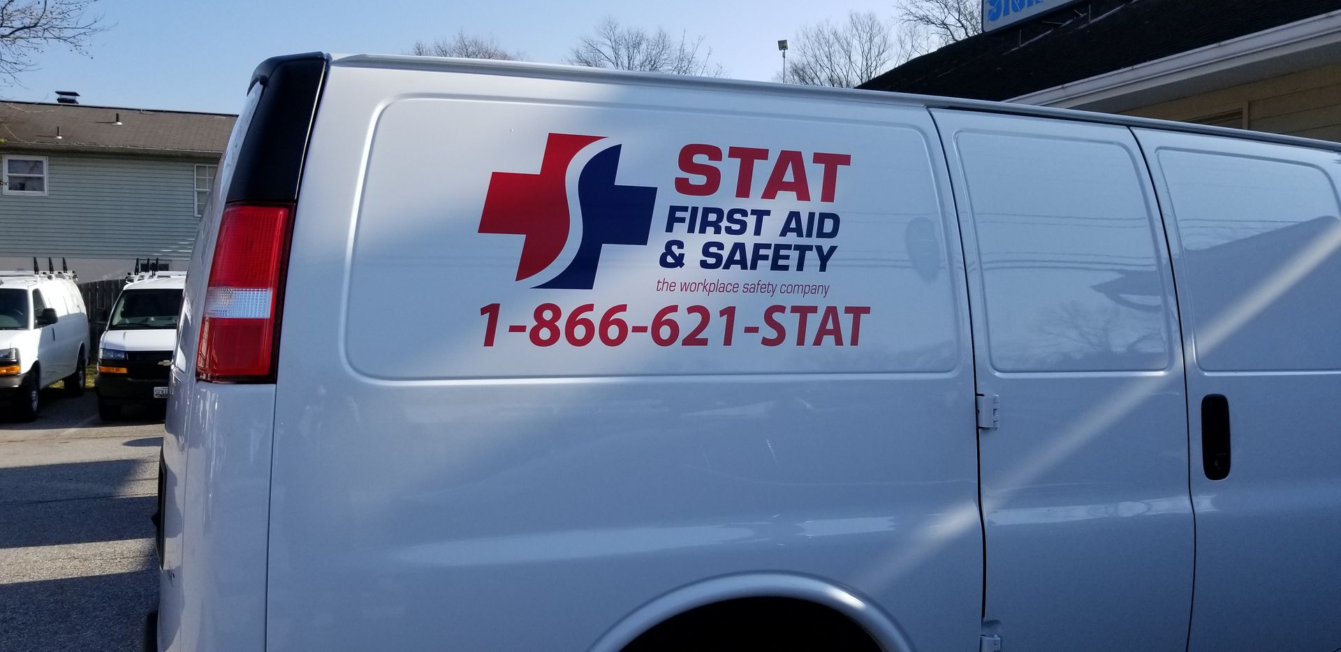 A white van with the word stat on the side