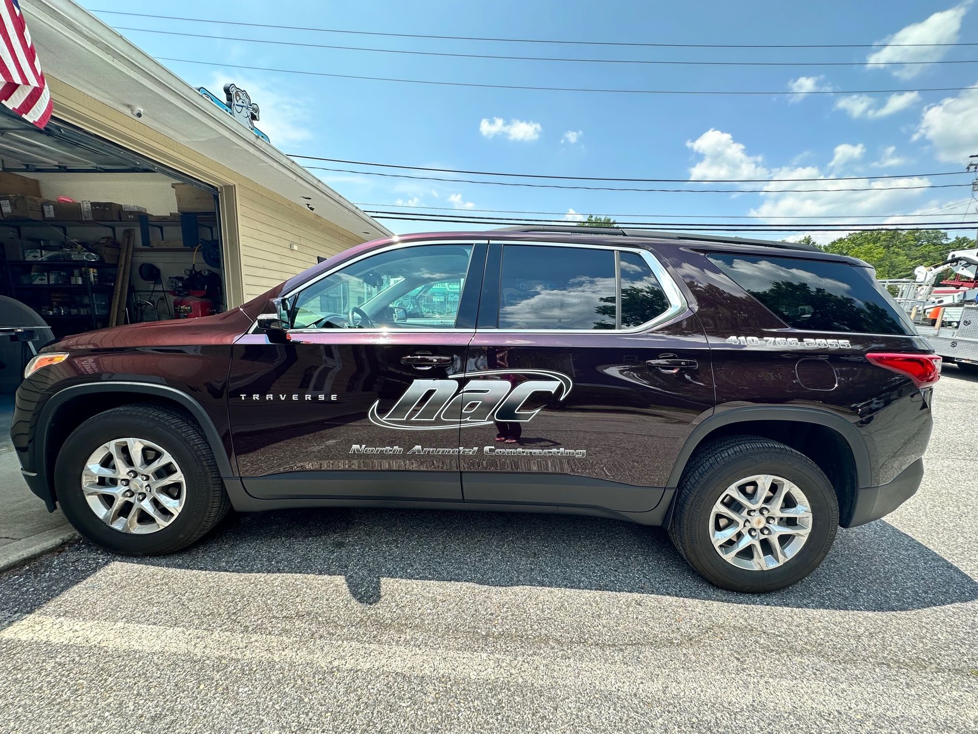 A brown suv is parked in front of a garage.