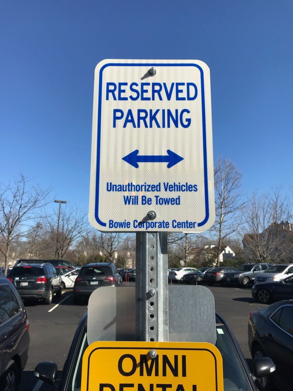 A reserved parking sign in a parking lot