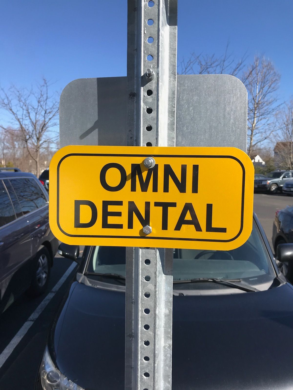 A yellow sign that says omni dental on it