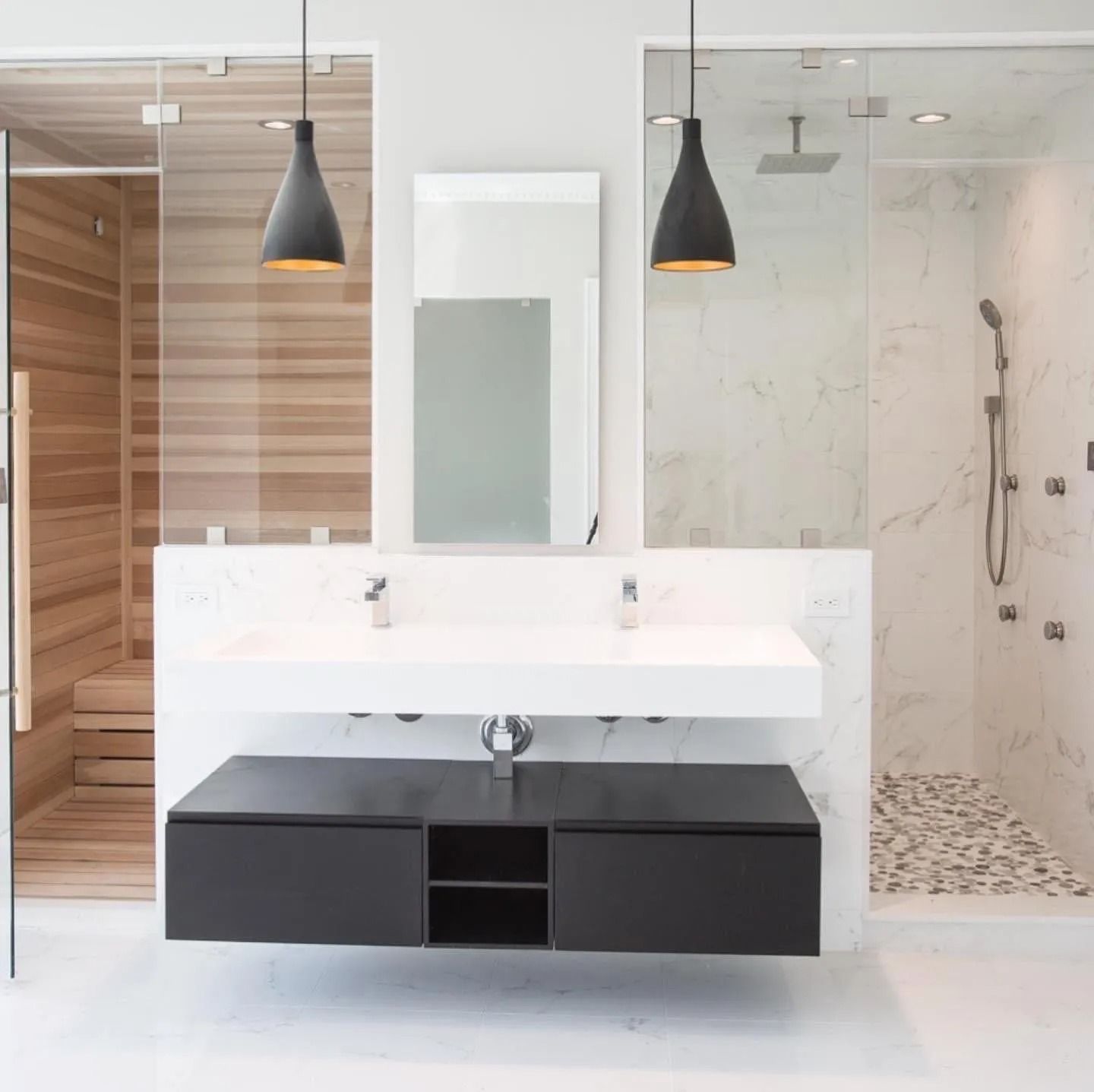 Modern bathroom with a sauna, shower, double vanity, and floating black cabinet.