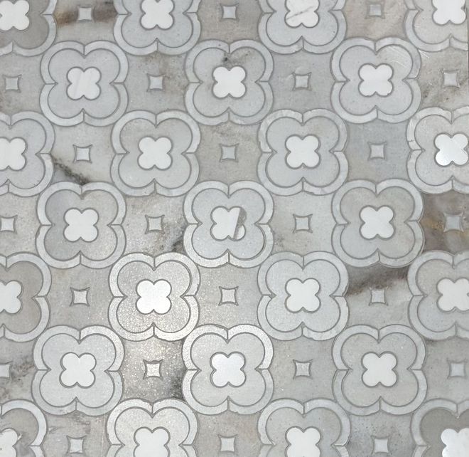 Gray and white patterned tile with a clover-like design on a marble-like background.