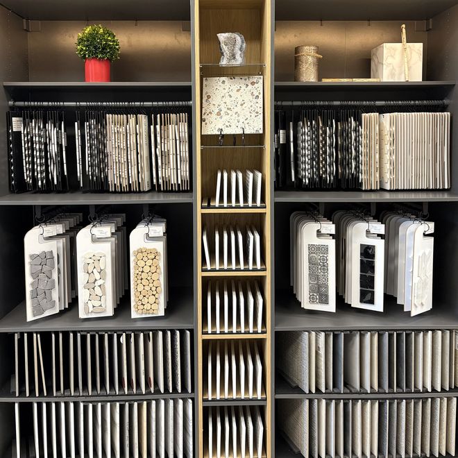 Shelves displaying samples of design materials like fabrics and tiles.