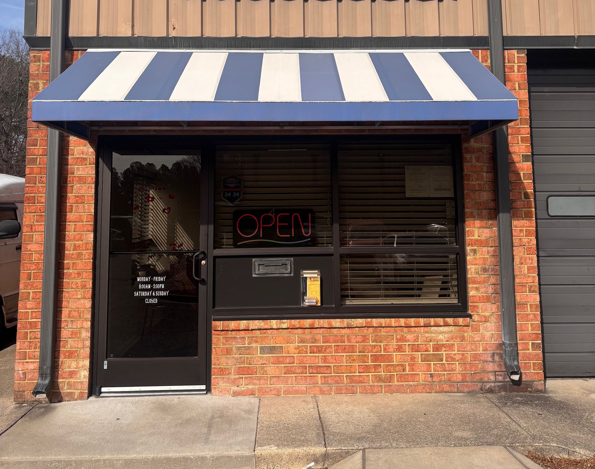 Storefront with brick facade, awning, door and window; 