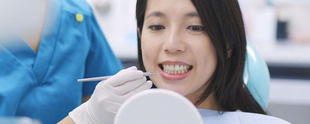 woman on the inspection of the teeth in dentistry