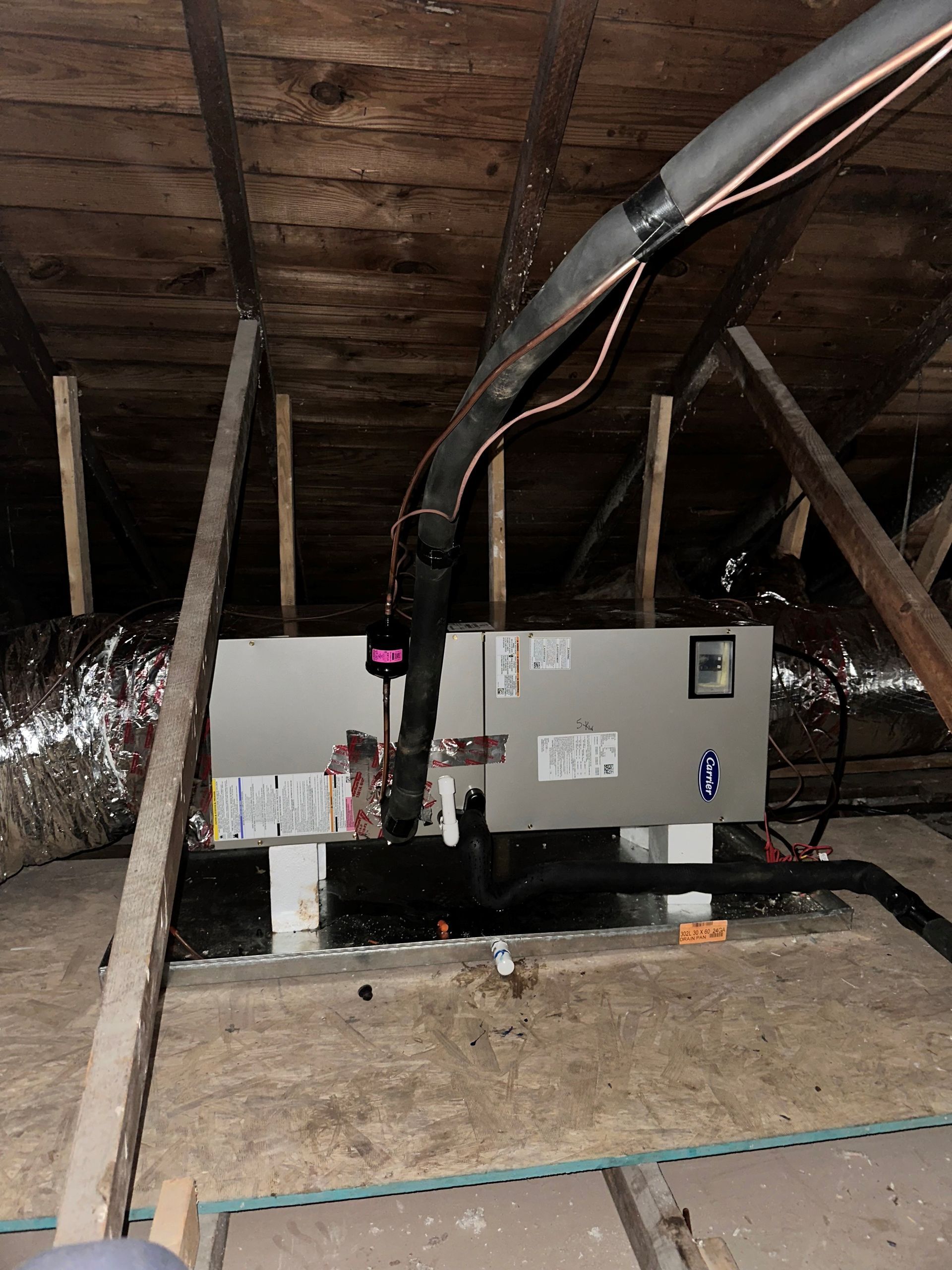 an air conditioner is installed in the attic of a house