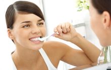 a woman brushing her teeth