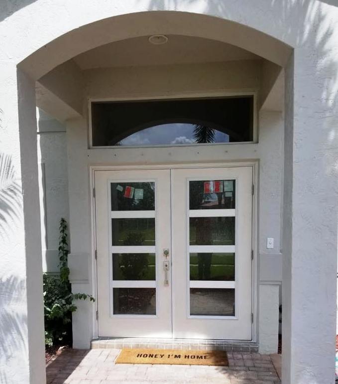 A white door with a yellow mat that says worry i 'm home