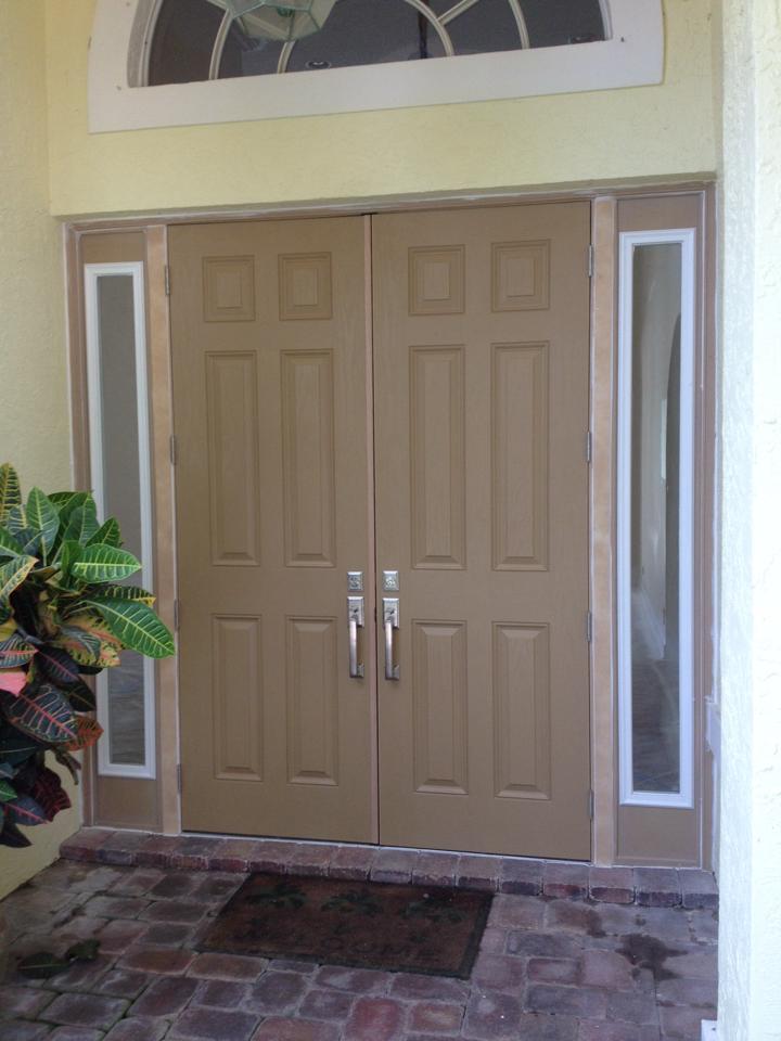 The front door of a house with a plant in front of it.