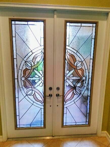 A pair of stained glass doors with a floral design on them.