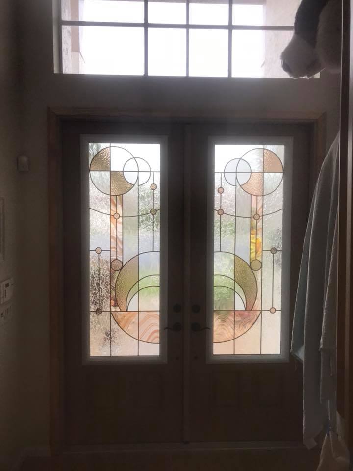 A pair of stained glass doors with a geometric design on them.