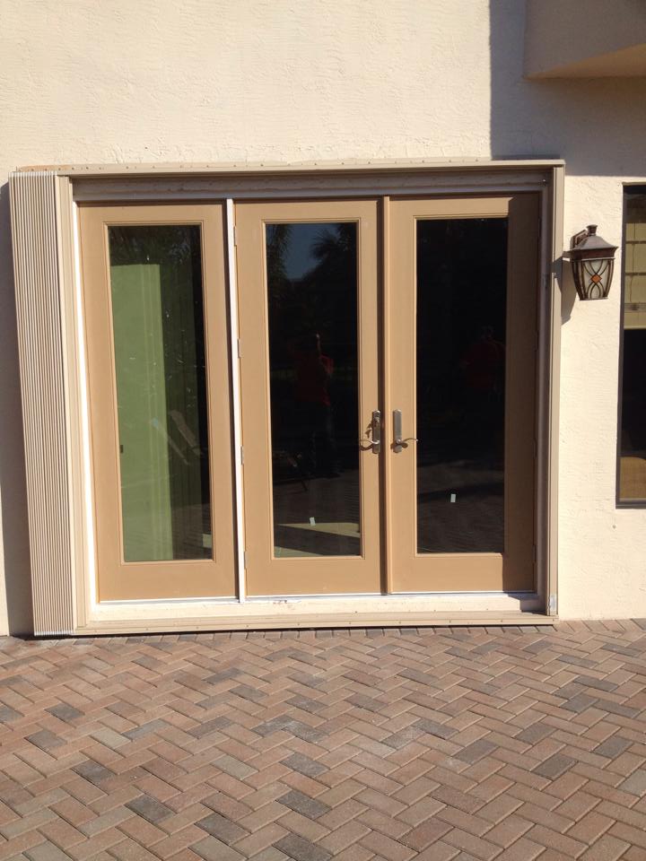 A sliding glass door is sitting on a brick driveway