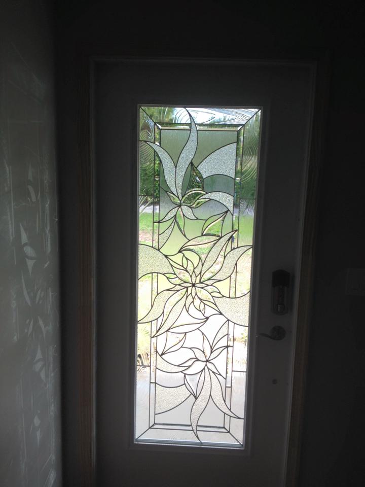 A stained glass door with a floral design on it.
