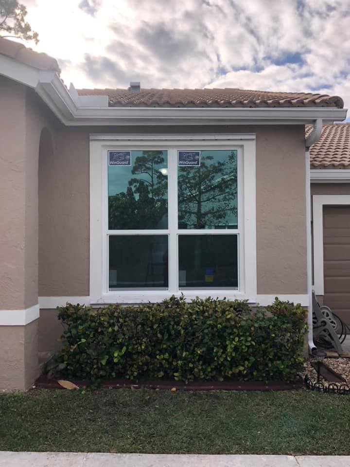 A house with a large window on the side of it.