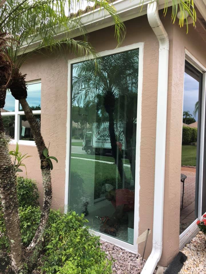 A house with a large window and a sliding glass door.