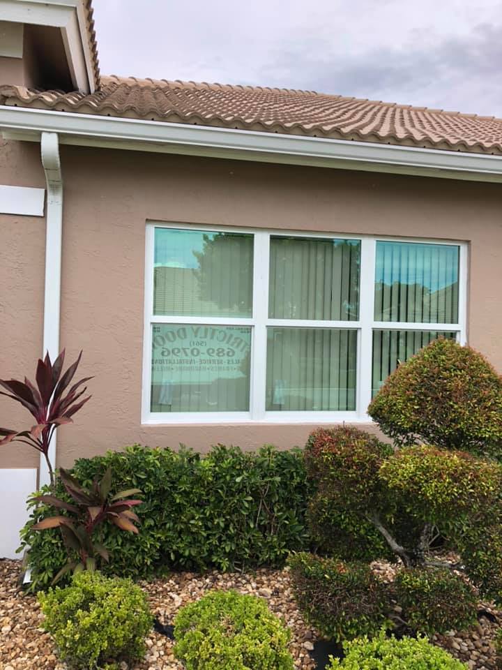 A house with a large window and a gutter on the side of it.