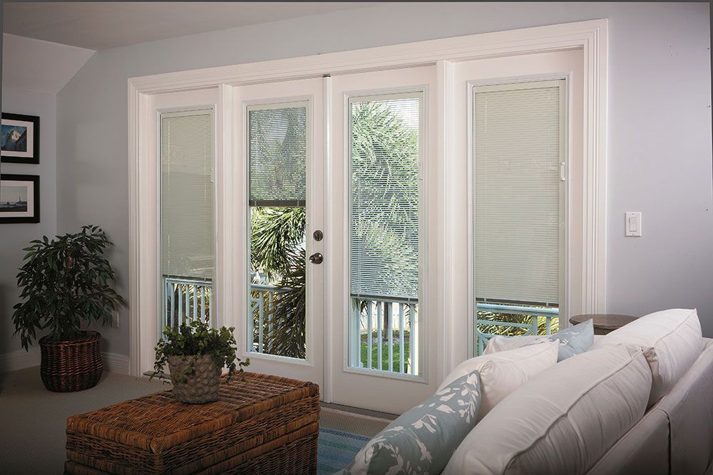 A living room with sliding glass doors and blinds
