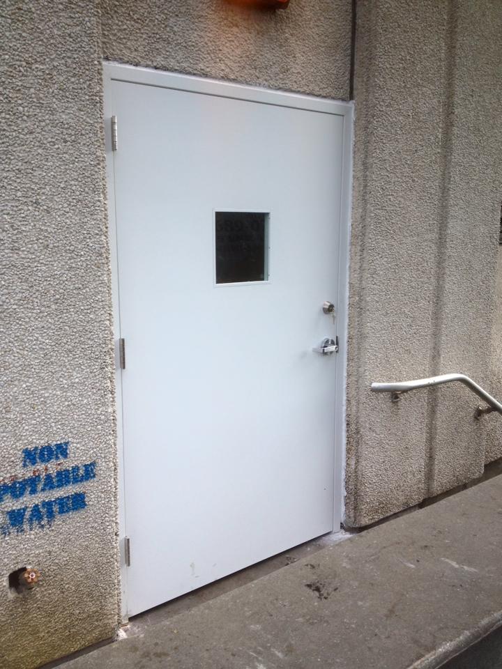 A white door with a window and a sign that says non potable water