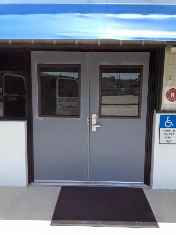 A door with a blue awning and a handicap sign