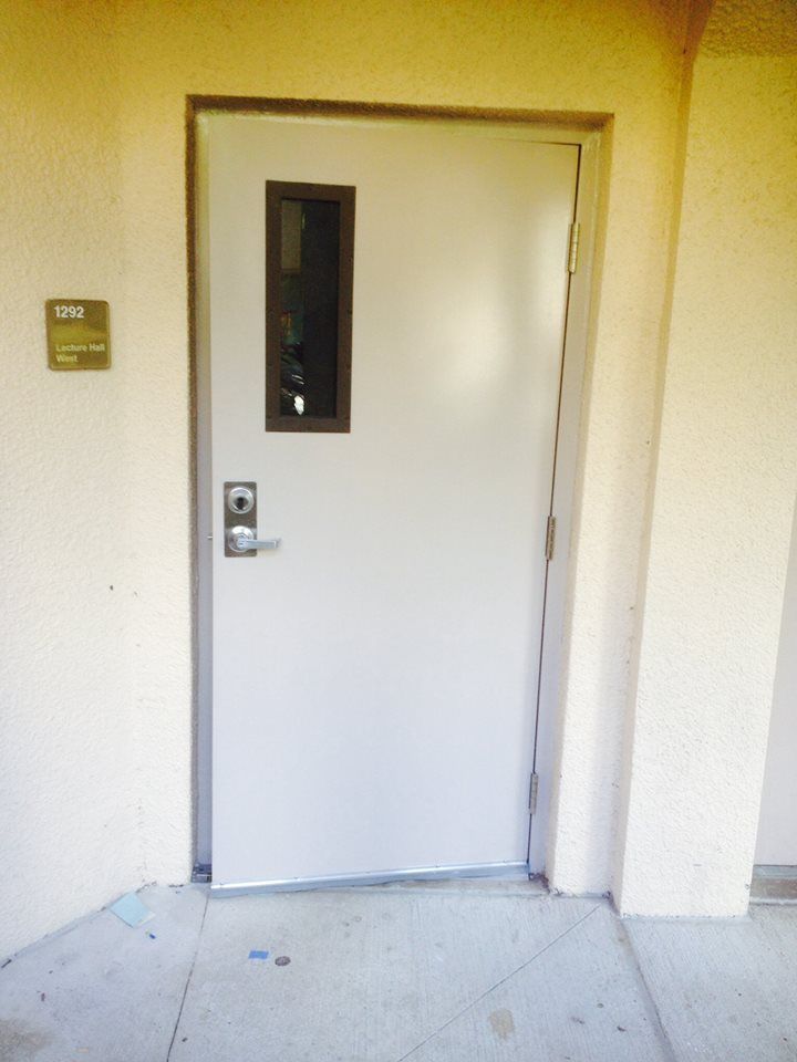 A white door with a small window on the side of it