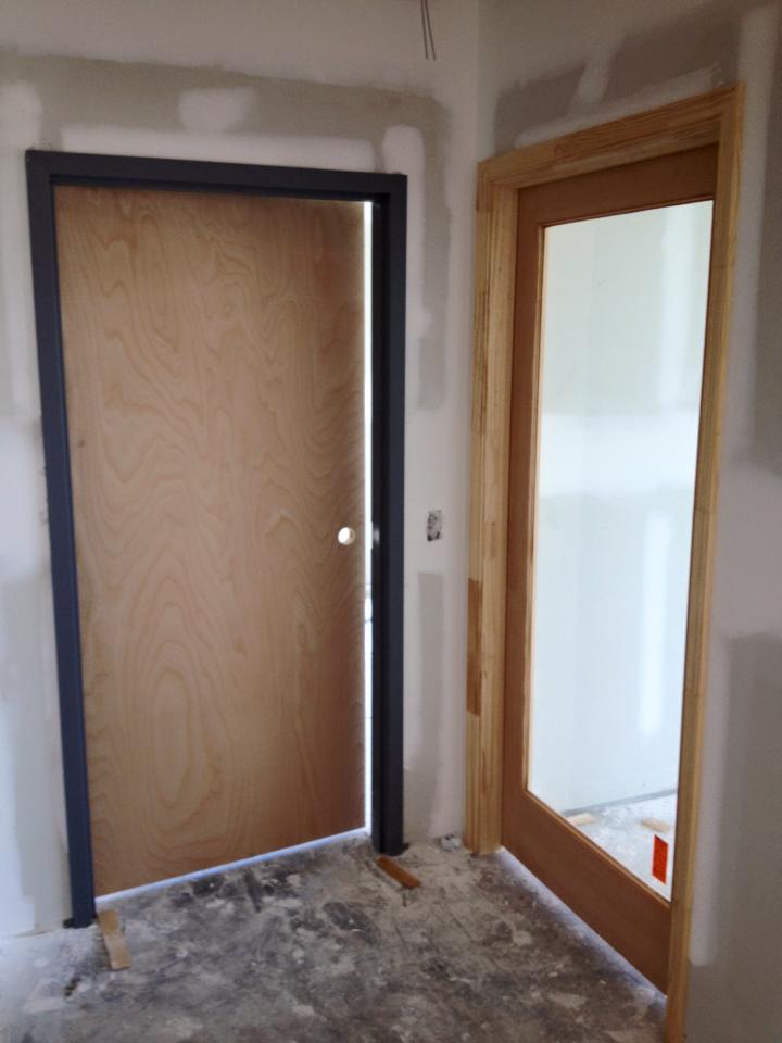 A room with a door that is open and a door that is closed