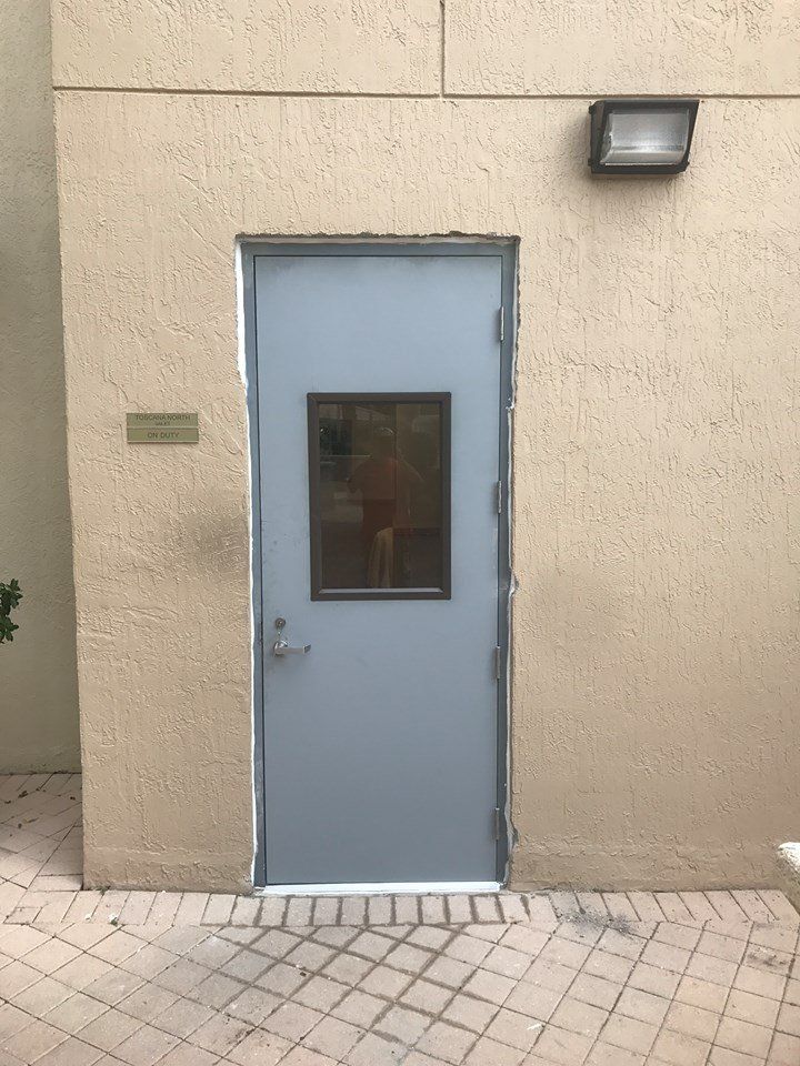 A door with a window on the side of a building.