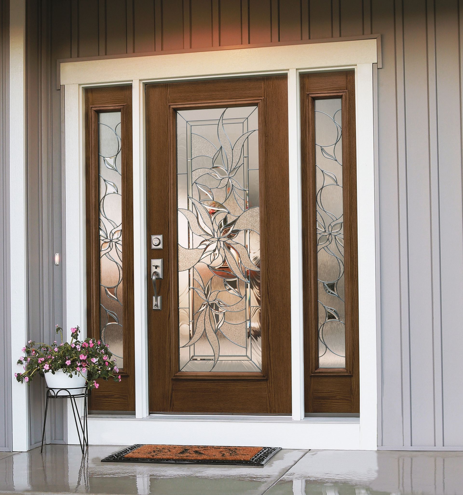 The front door of a house has a floral design on the glass