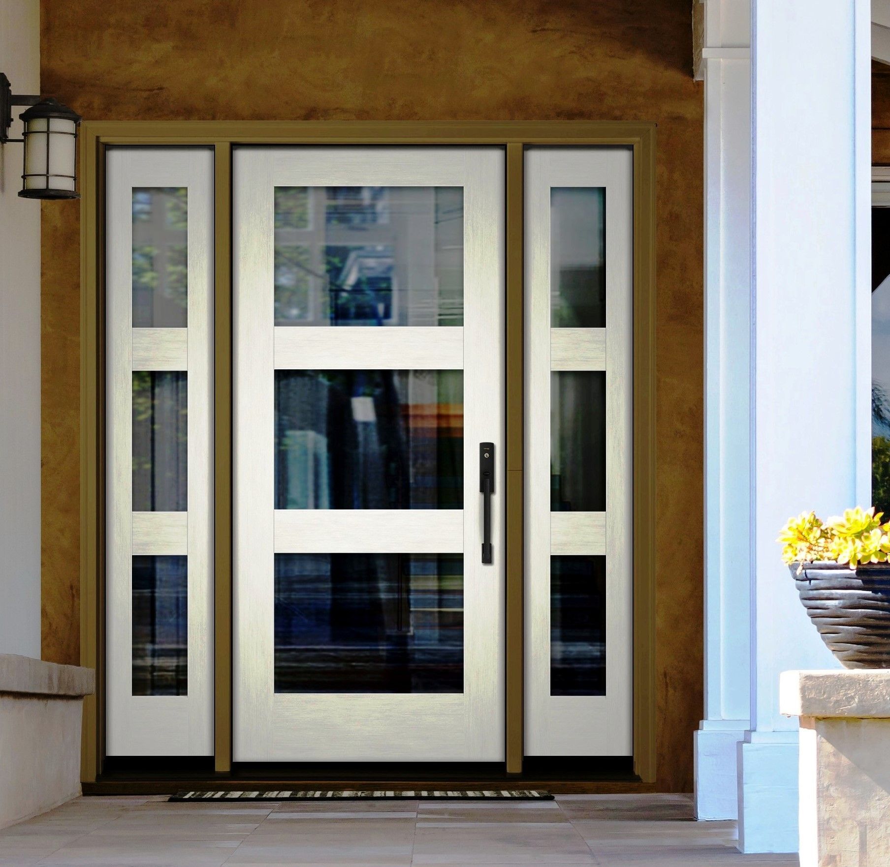 A large white door with a lot of windows is on a porch.