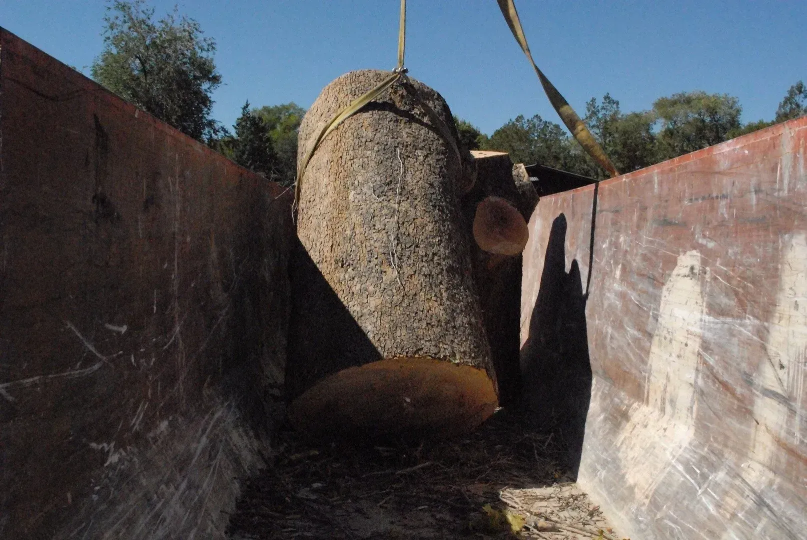 A large rock is being lifted by a crane