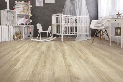Bright nursery with white crib, rocking horse, shelves, and light wood flooring