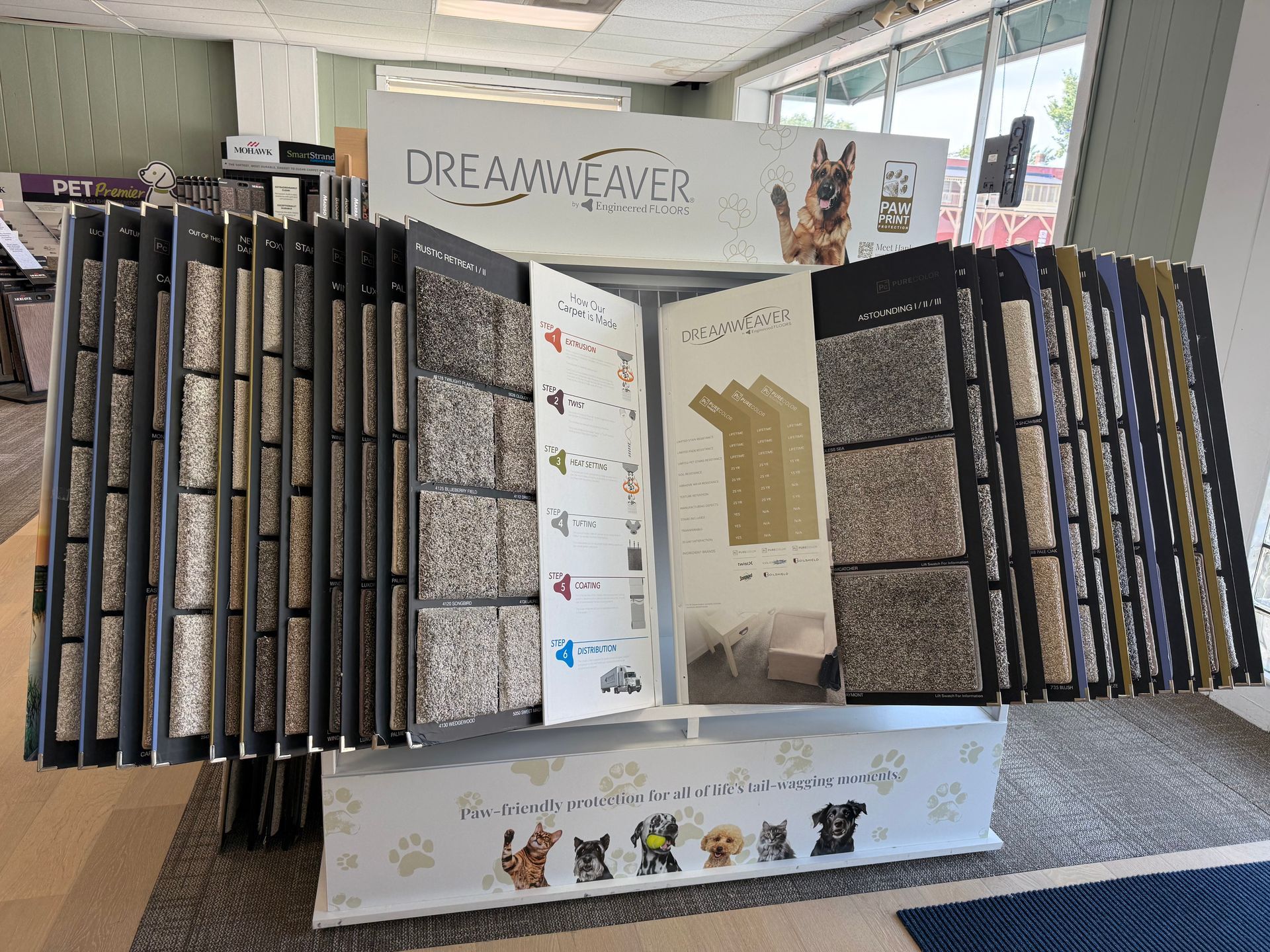 Display of Dream Weaver quilt panels and fabric samples in a store or showroom.