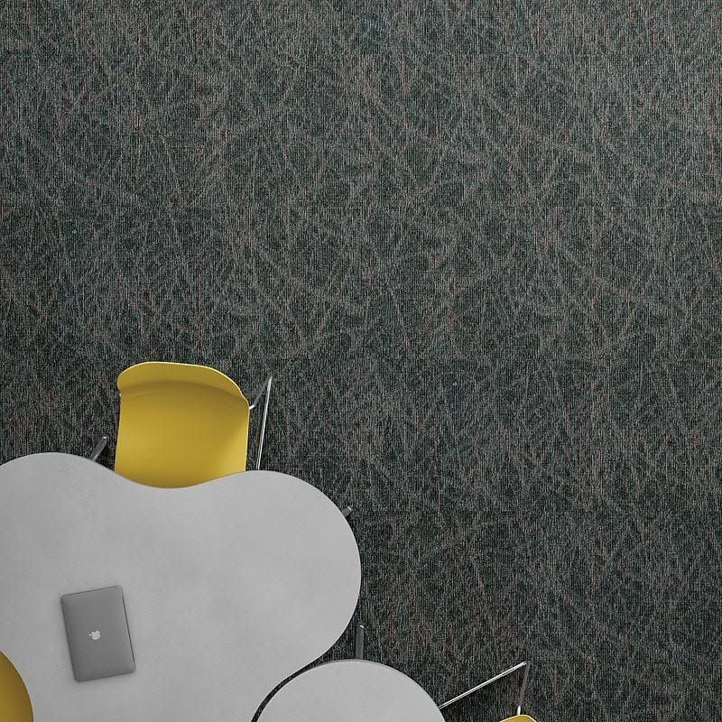 Top-down view of a small yellow chair beside a white cloud-shaped table on a gray textured floor.