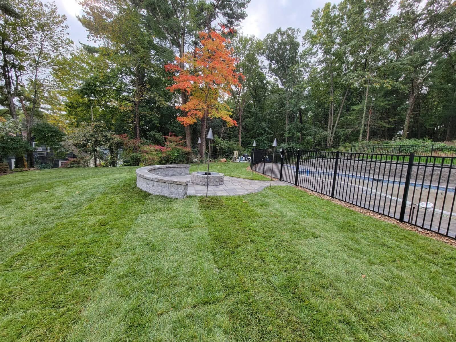 Fenced patio, outdoor fireplace, mowed lawn
