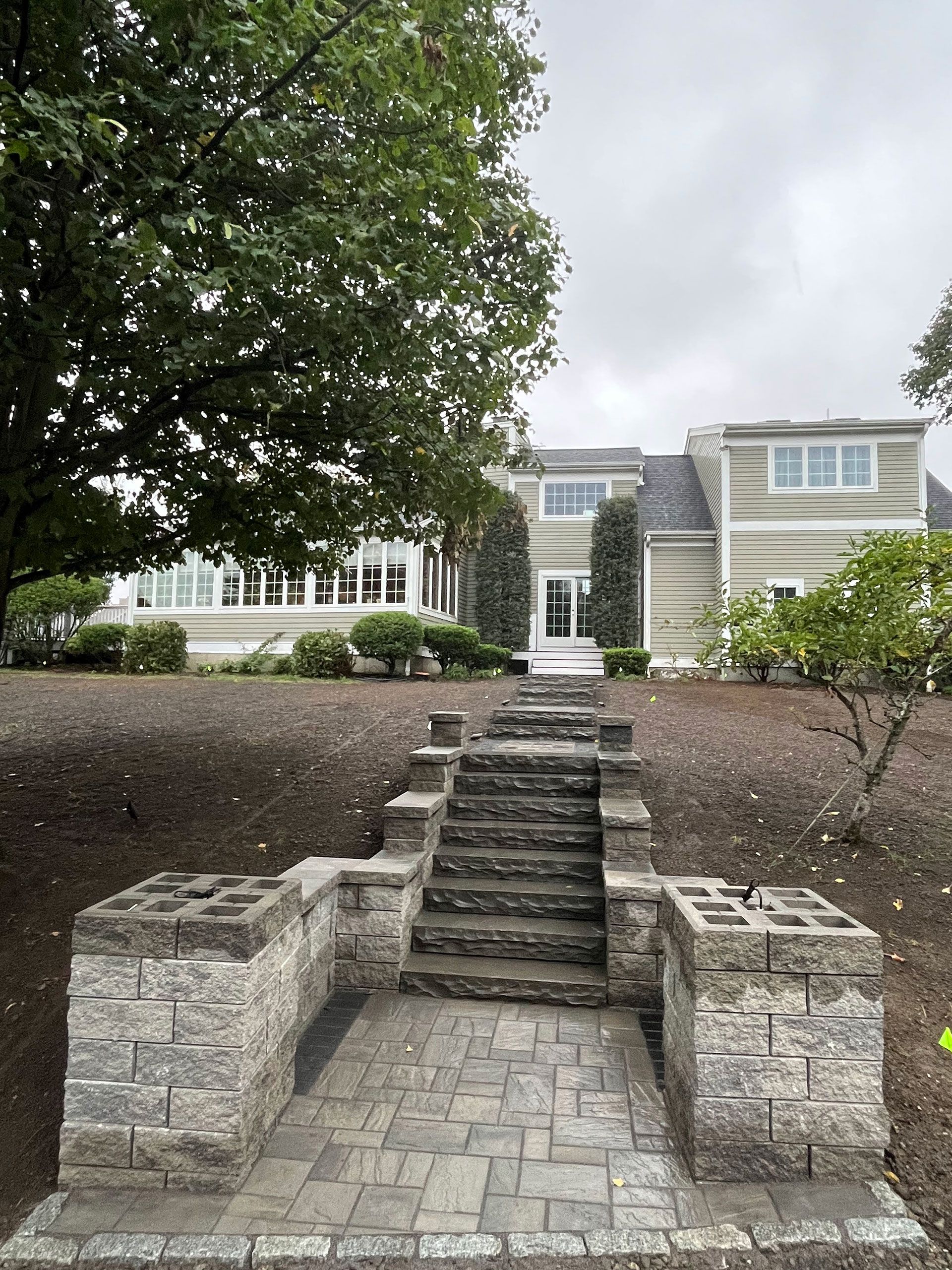 Finished hardscaping work for entrance and step leading to house front door