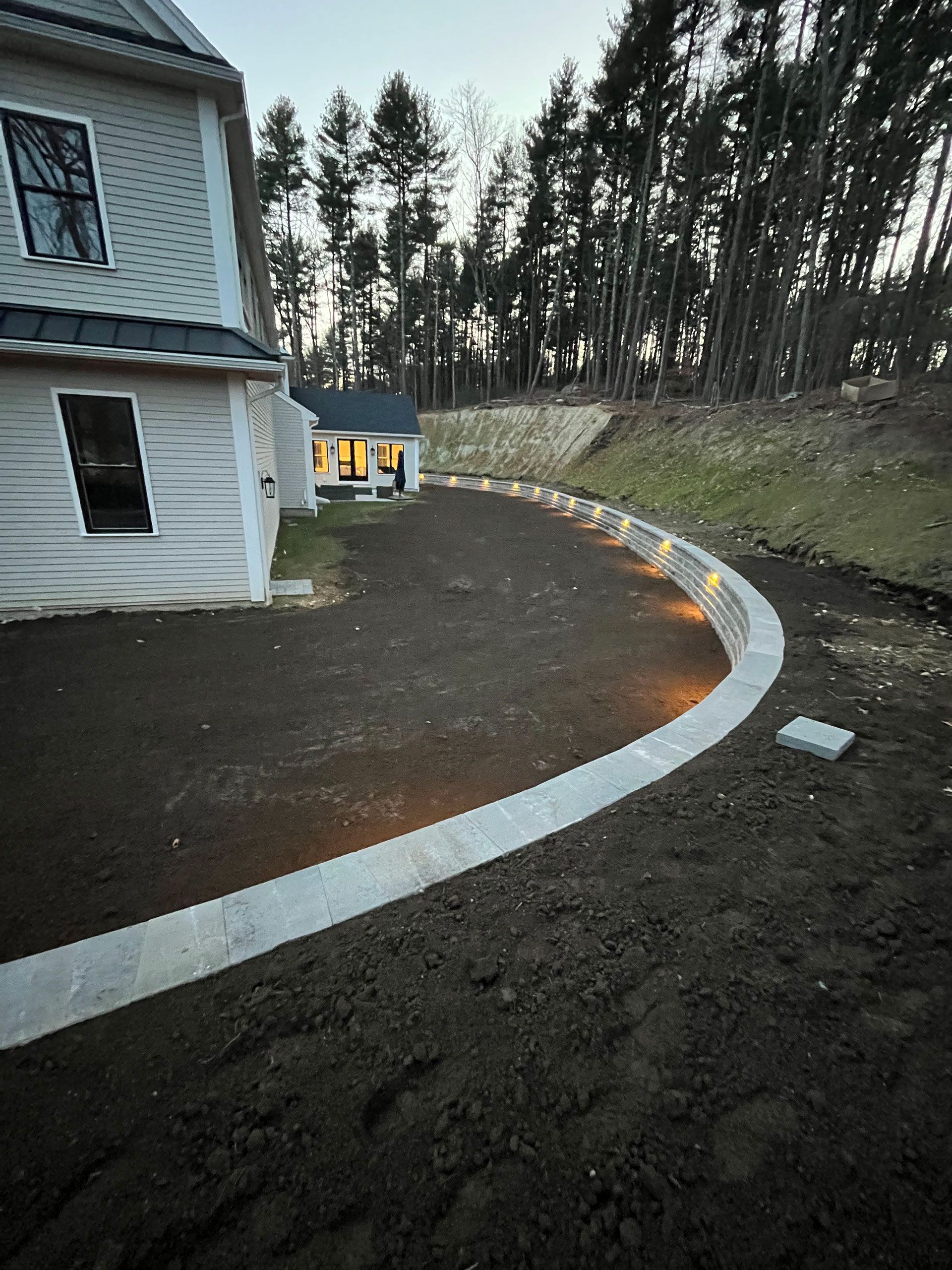 Landscape lighting on a home's retaining wall
