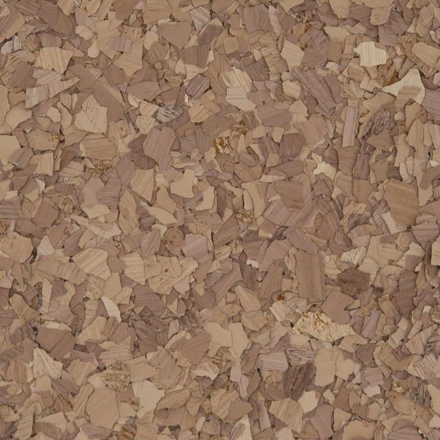 Close-up of a textured surface featuring small, irregularly shaped wood chips in shades of light brown and tan.
