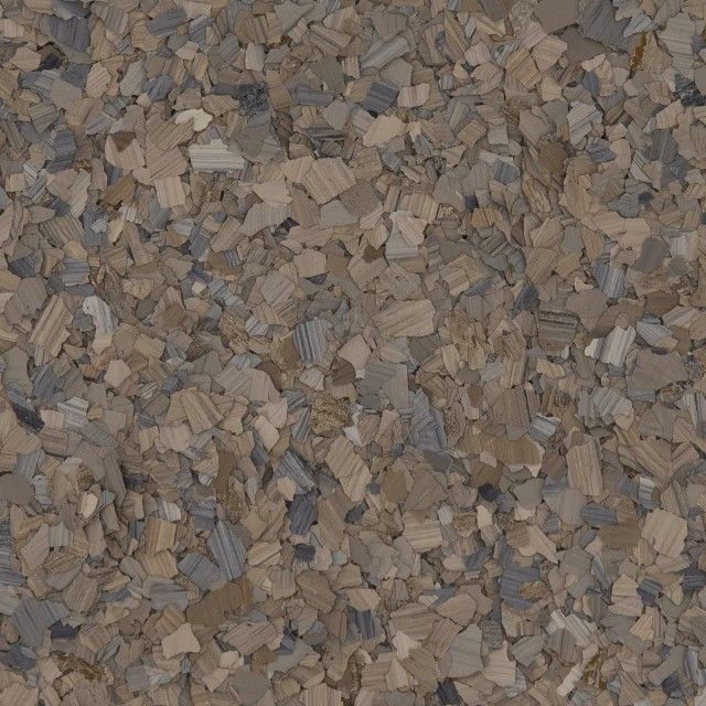 A close-up of multi-sized, decorative vinyl floor chips in shades of tan, beige, gray, and brown.