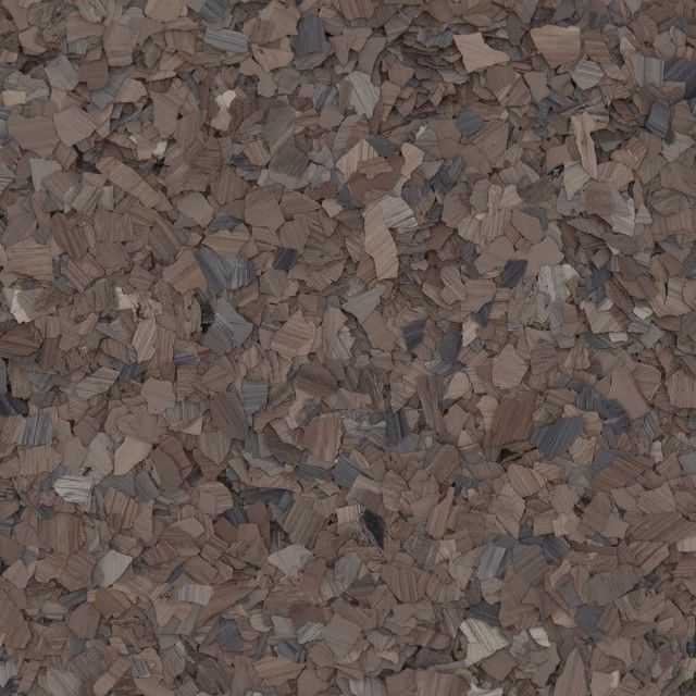 A dense, textured pattern of small, irregularly shaped brown and dark grey vinyl paint flakes used for floor coatings.