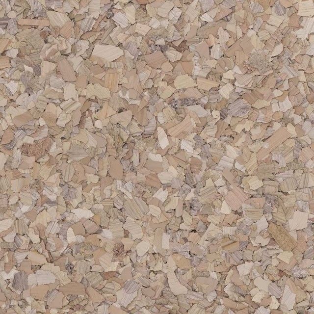 A close-up texture of light brown and tan granulated cork, featuring small, irregular, compressed wood-like flakes.