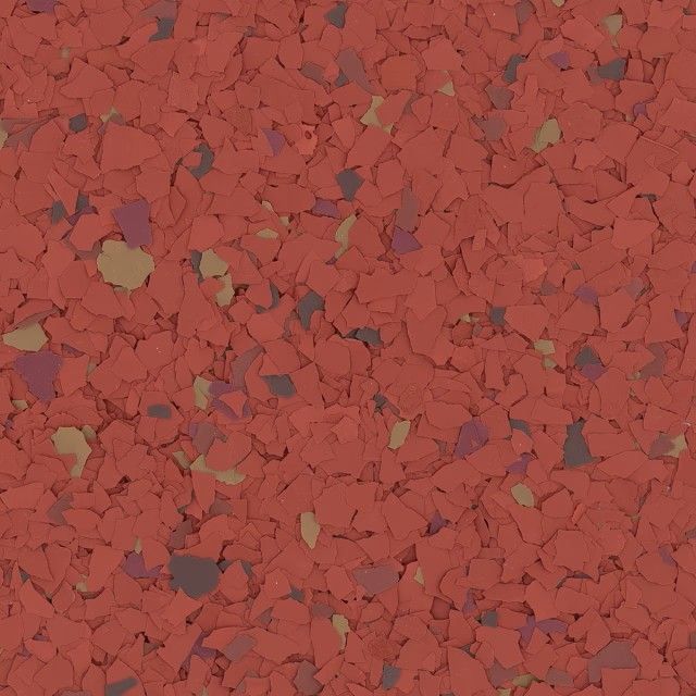 A close-up of a speckled flooring surface with red, maroon, and tan chips embedded in a red background.