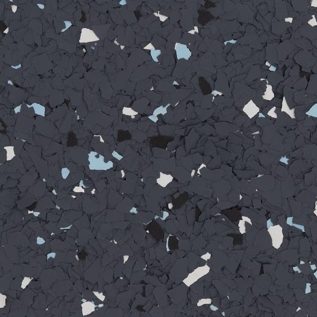 A dark gray, textured floor surface with speckled flecks of white, black, and light blue throughout.