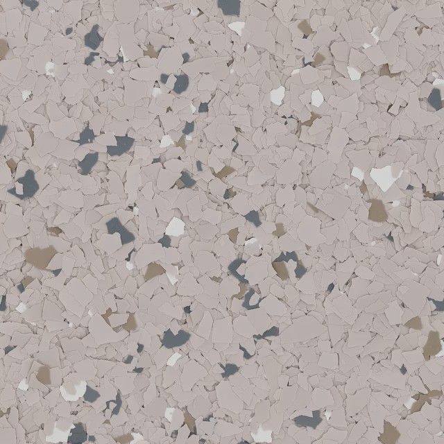 Close-up of a speckled flooring surface with beige, white, gray, and brown flecks embedded in a light tan base.