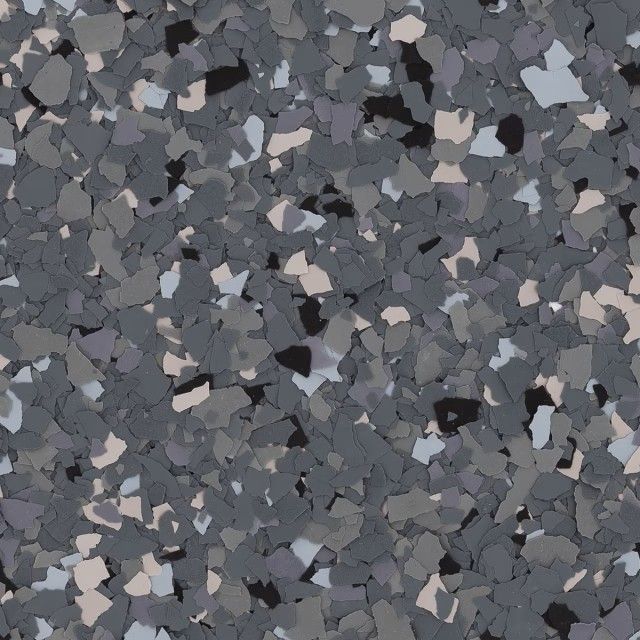 A close-up view of grey, black, and white decorative vinyl floor flakes, creating a speckled, multi-tonal texture.