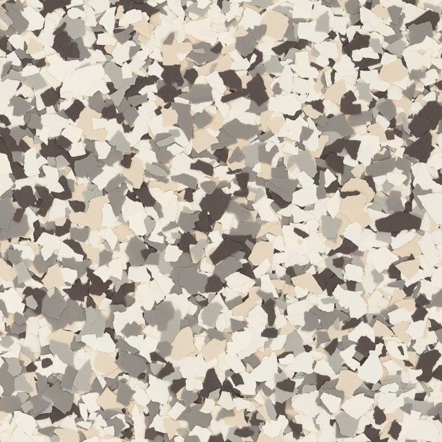 A textured decorative floor coating featuring a mix of white, beige, light gray, and dark brown paint flakes.