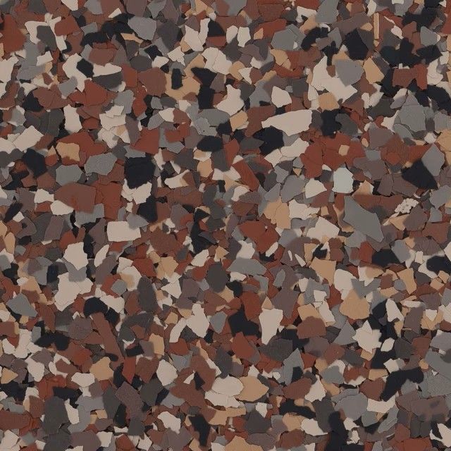 A close-up of decorative vinyl paint chips in shades of brown, tan, gray, and black for epoxy floor coating.
