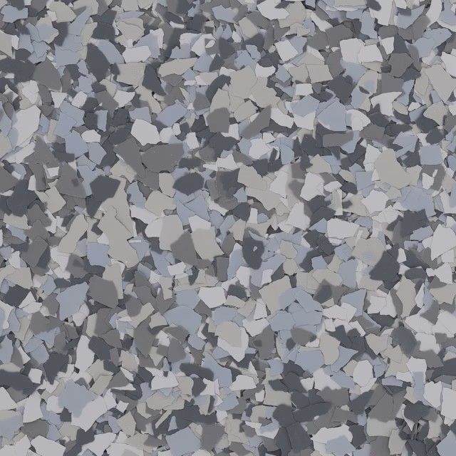A close-up of gray, white, and charcoal-colored vinyl paint flakes used for decorative floor coating.