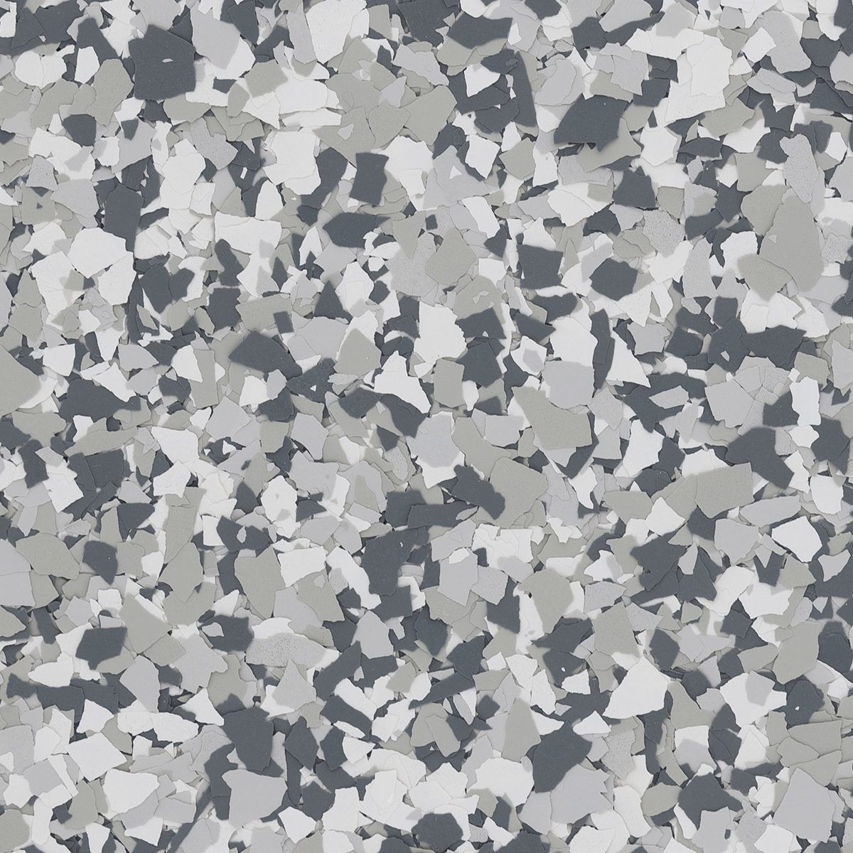 A close-up texture of granite-style epoxy floor flakes in shades of dark gray, light gray, and white.
