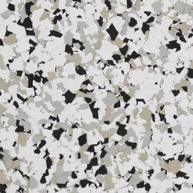 A pattern of randomly scattered black, white, gray, and tan paint flakes, commonly used for decorative epoxy floor coating.