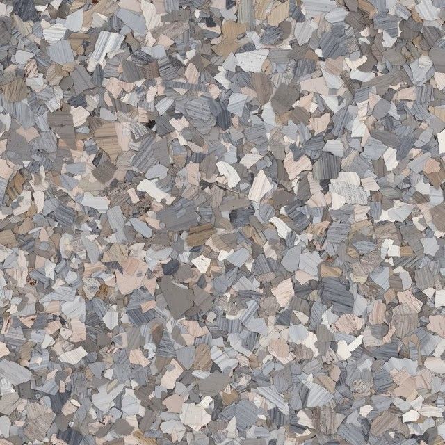 A decorative floor coating texture consisting of multicolored grey, tan, and white vinyl flakes.